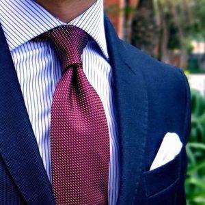 navy blue suit and red tie